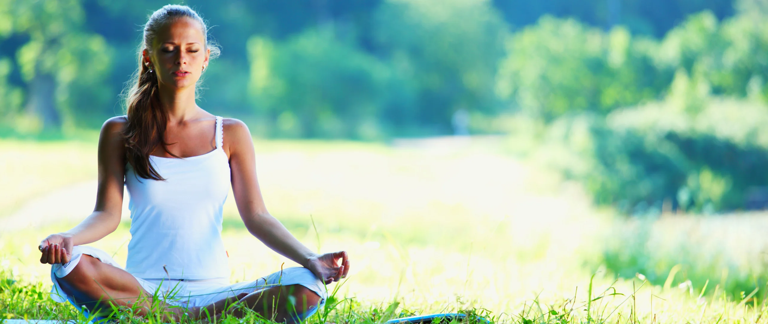 Yoga mat rolled up next to a window with soft morning light.